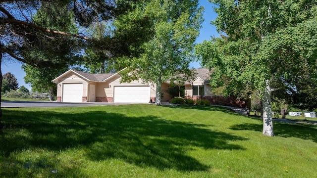 4901 Itana Cir, Bozeman, MT 59715 - view of front facade with a front lawn, brick siding, and an attached garage