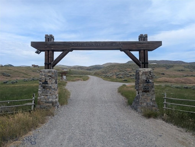 51 Highlander Dr, Three Forks, MT 59752 - view of dirt / gravel driveway featuring a mountain view and a view of rural / pastoral area