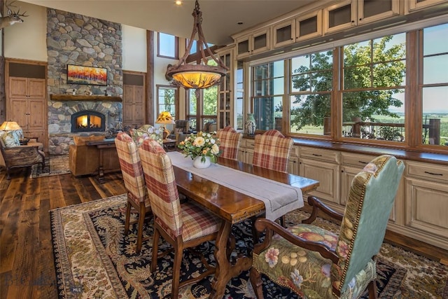 390 Hayrake Ln, Bozeman, MT 59715 - dining space with dark wood-style floors and a fireplace