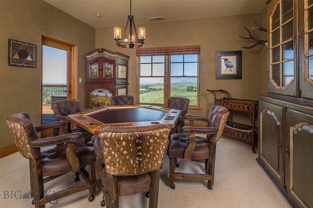 390 Hayrake Ln, Bozeman, MT 59715 - dining area featuring light colored carpet, plenty of natural light, and a chandelier