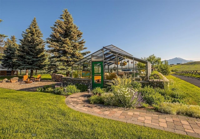 390 Hayrake Ln, Bozeman, MT 59715 - view of playground with a lawn, an exterior structure, and a mountain view