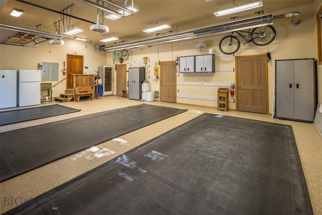 390 Hayrake Ln, Bozeman, MT 59715 - garage featuring freestanding refrigerator, a garage door opener, and electric panel