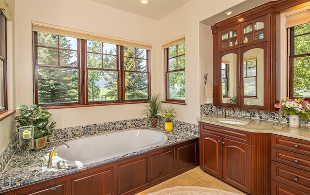 390 Hayrake Ln, Bozeman, MT 59715 - bathroom featuring a bath, vanity, tile patterned floors, decorative backsplash, and recessed lighting