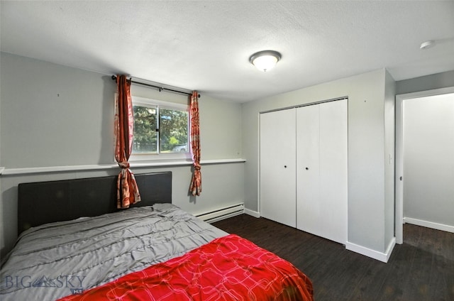 801 Iowa St, Belgrade, MT 59714 - bedroom featuring a baseboard heating unit, wood finished floors, and a closet