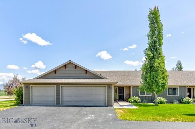 9848 Durston Rd Unit A, Bozeman, MT 59718 - ranch-style house with board and batten siding, driveway, a front yard, an attached garage, and roof with shingles