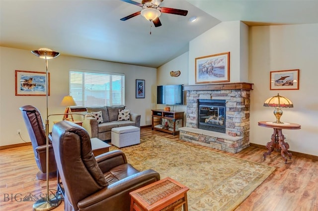 9848 Durston Rd Unit A, Bozeman, MT 59718 - living room with a ceiling fan, wood finished floors, vaulted ceiling, and a stone fireplace
