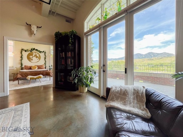 140 Village Crossing Way Unit 1J, Bozeman, MT 59715 - living area featuring finished concrete flooring, a mountain view, and a towering ceiling