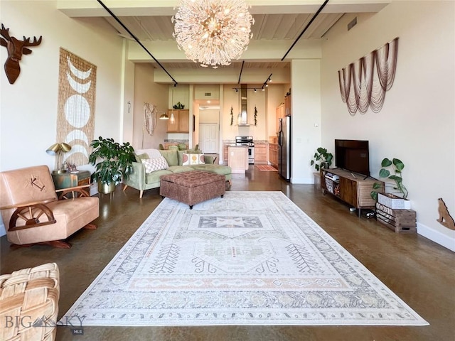 140 Village Crossing Way Unit 1J, Bozeman, MT 59715 - living area featuring a chandelier, beamed ceiling, and concrete flooring