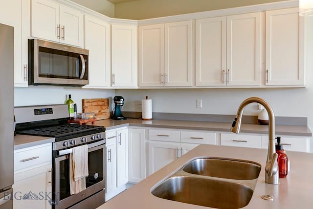 2002 Chipset St Unit A, Bozeman, MT 59718 - kitchen with stainless steel appliances, white cabinetry, and light countertops