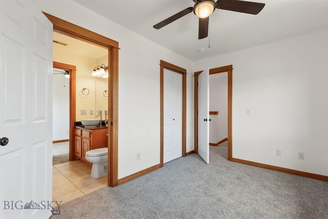 332 N Cottonwood Rd Unit F, Bozeman, MT 59718 - unfurnished bedroom featuring light colored carpet, connected bathroom, and ceiling fan