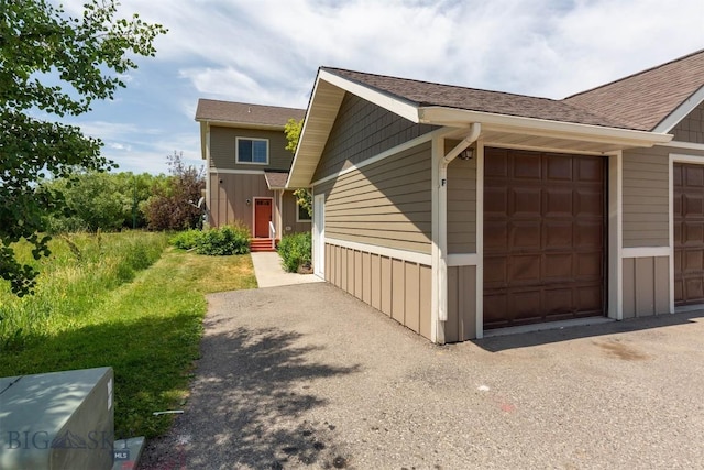 332 N Cottonwood Rd Unit F, Bozeman, MT 59718 - view of side of home featuring board and batten siding and a shingled roof