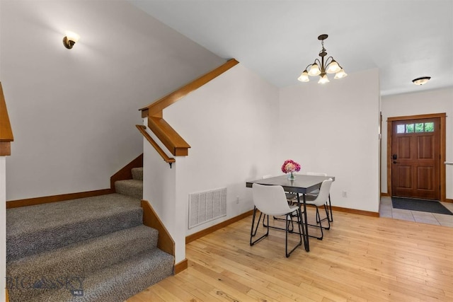 332 N Cottonwood Rd Unit F, Bozeman, MT 59718 - dining room with a chandelier, stairs, and hardwood / wood-style flooring