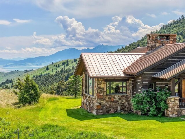 94 Sky Band Trl, Livingston, MT 59047 - exterior space with a standing seam roof, a mountain view, a metal roof, stone siding, and a chimney