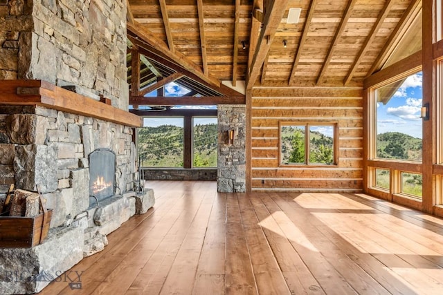 94 Sky Band Trl, Livingston, MT 59047 - unfurnished living room with a wood ceiling with exposed beams, hardwood / wood-style flooring, a fireplace, and high vaulted ceiling