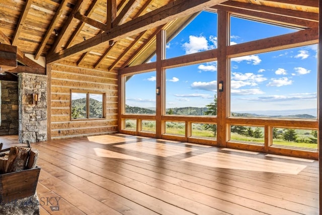 94 Sky Band Trl, Livingston, MT 59047 - unfurnished sunroom featuring a wood ceiling with exposed beams, a deck with mountain view, hardwood / wood-style flooring, and high vaulted ceiling