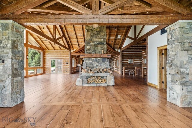 94 Sky Band Trl, Livingston, MT 59047 - unfurnished living room featuring wood-type flooring, a wood ceiling with exposed beams, and high vaulted ceiling