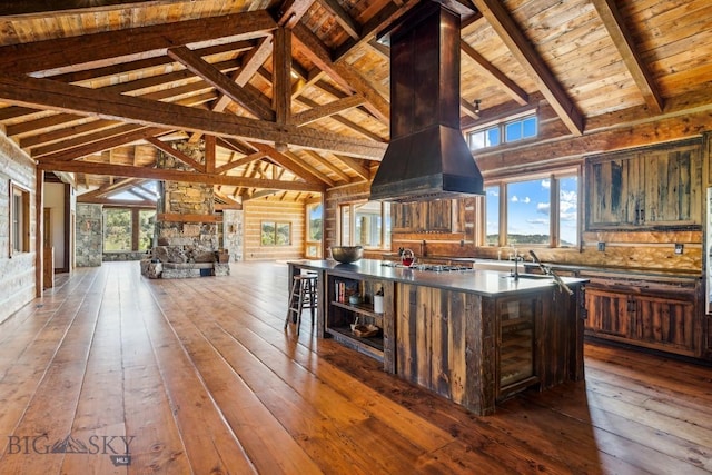 94 Sky Band Trl, Livingston, MT 59047 - kitchen featuring dark wood-type flooring, extractor fan, dark countertops, a center island, and open floor plan