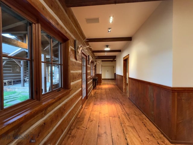 94 Sky Band Trl, Livingston, MT 59047 - corridor featuring wood walls, light wood-type flooring, a wainscoted wall, and beamed ceiling