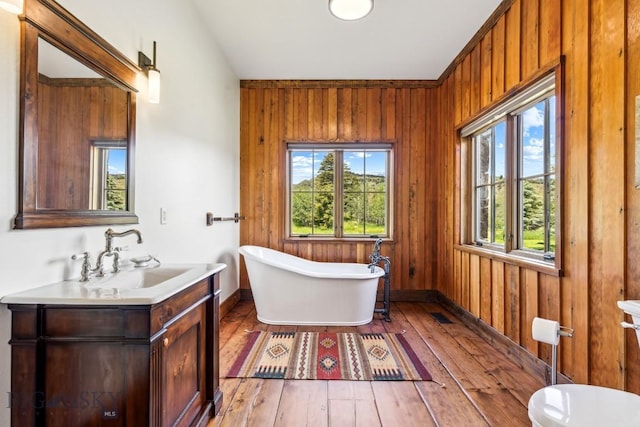 94 Sky Band Trl, Livingston, MT 59047 - full bathroom with vanity, a soaking tub, wood-type flooring, and wood walls