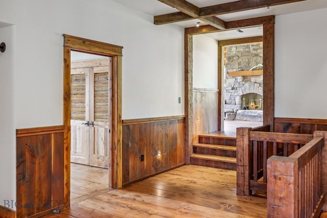94 Sky Band Trl, Livingston, MT 59047 - corridor with a wainscoted wall, beamed ceiling, wooden walls, and wood-type flooring