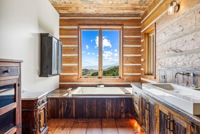 94 Sky Band Trl, Livingston, MT 59047 - full bath with wooden ceiling, a bath, vanity, wood-type flooring, and wood walls