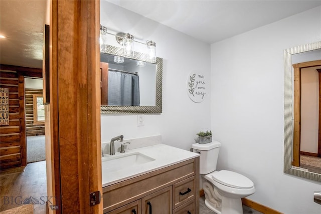 107 Antelope Meadows Rd, Ennis, MT 59729 - bathroom featuring rustic walls, vanity, and wood finished floors