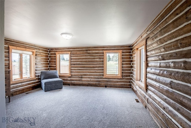107 Antelope Meadows Rd, Ennis, MT 59729 - unfurnished room with log walls, plenty of natural light, and carpet flooring
