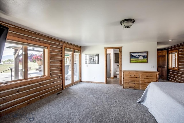 107 Antelope Meadows Rd, Ennis, MT 59729 - carpeted bedroom featuring access to exterior, log walls, and ensuite bath