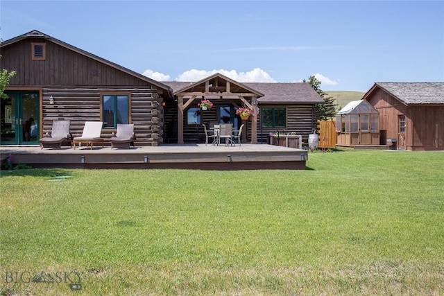107 Antelope Meadows Rd, Ennis, MT 59729 - back of house featuring log siding, a deck, a yard, and an outbuilding