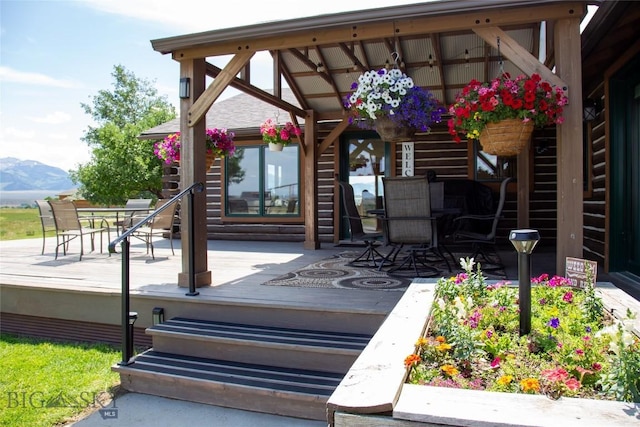 107 Antelope Meadows Rd, Ennis, MT 59729 - view of patio with a deck with mountain view and outdoor dining space