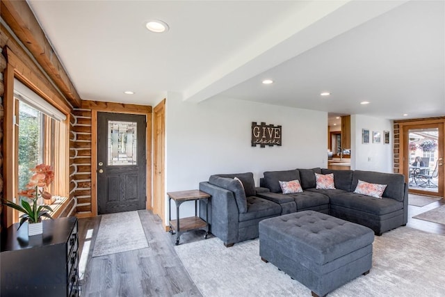 107 Antelope Meadows Rd, Ennis, MT 59729 - living room featuring plenty of natural light, log walls, recessed lighting, and light wood-style floors