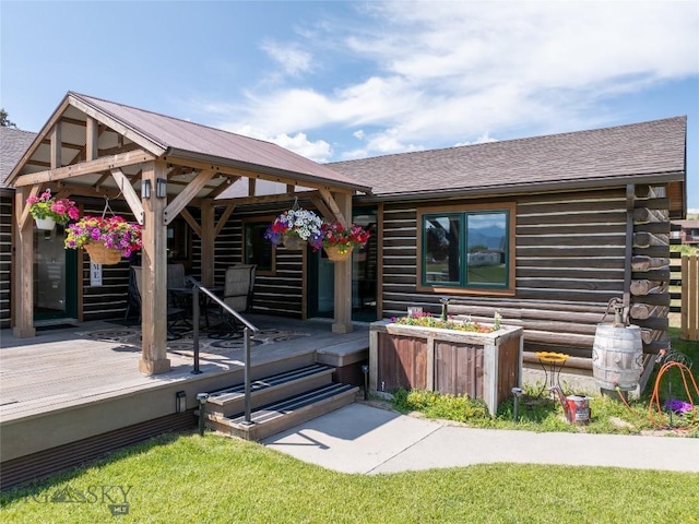 107 Antelope Meadows Rd, Ennis, MT 59729 - doorway to property with log exterior, a deck, and a shingled roof