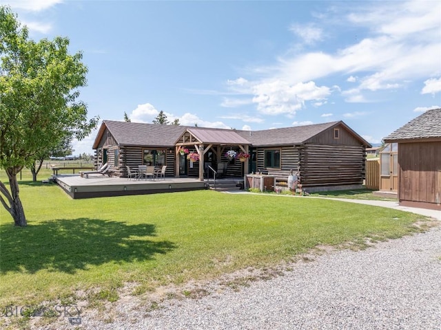107 Antelope Meadows Rd, Ennis, MT 59729 - back of house with log siding, a lawn, a shed, and a wooden deck