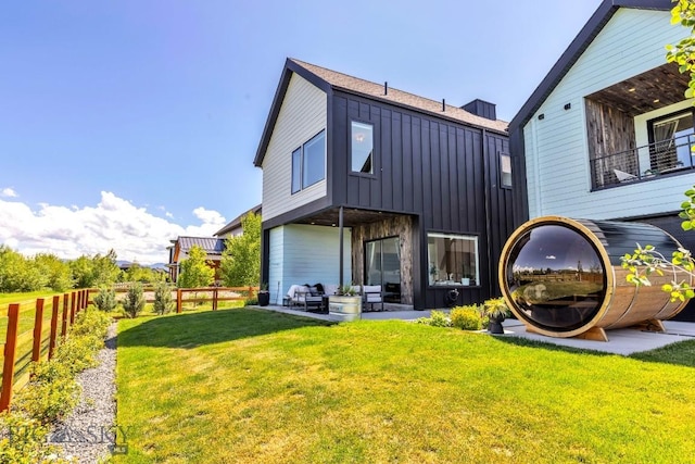 1492 Windrow Dr, Bozeman, MT 59718 - rear view of property featuring board and batten siding, a fenced backyard, and an outdoor hangout area