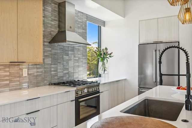 1492 Windrow Dr, Bozeman, MT 59718 - kitchen featuring wall chimney exhaust hood, high quality appliances, backsplash, and light countertops
