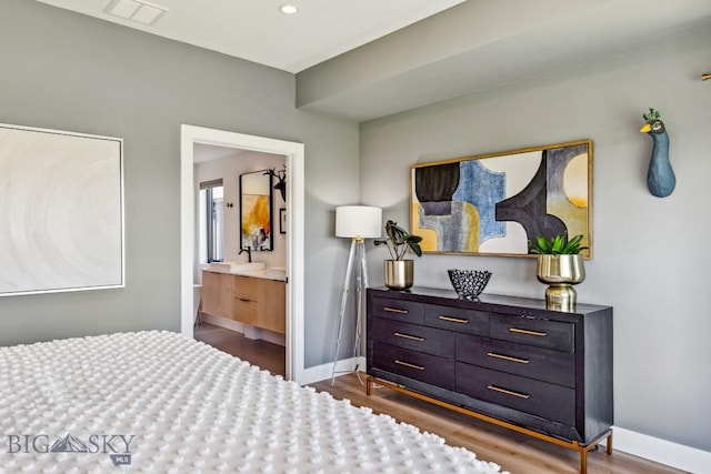 1492 Windrow Dr, Bozeman, MT 59718 - bedroom with dark wood-type flooring and connected bathroom