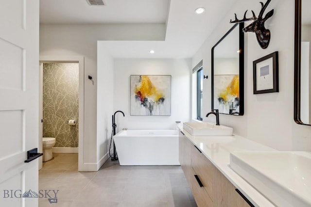 1492 Windrow Dr, Bozeman, MT 59718 - full bathroom with a freestanding bath, double vanity, recessed lighting, and tile patterned flooring