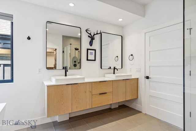 1492 Windrow Dr, Bozeman, MT 59718 - bathroom featuring double vanity, a stall shower, tile patterned flooring, and recessed lighting