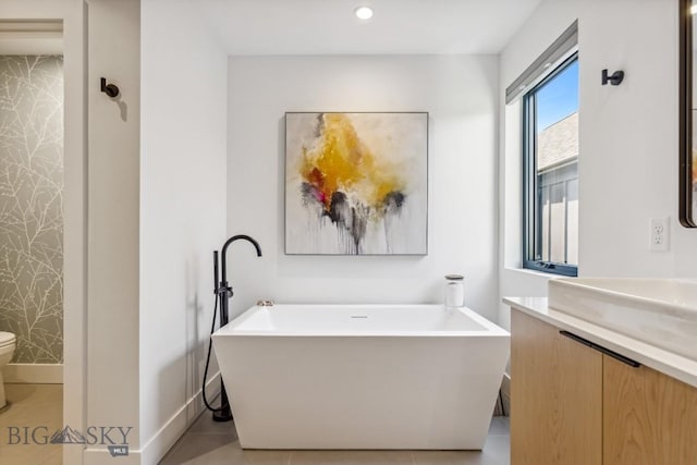 1492 Windrow Dr, Bozeman, MT 59718 - bathroom featuring a freestanding bath, vanity, tile patterned floors, and recessed lighting