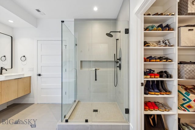 1492 Windrow Dr, Bozeman, MT 59718 - bathroom featuring vanity, a shower stall, tile patterned floors, recessed lighting, and a spacious closet