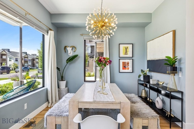 1492 Windrow Dr, Bozeman, MT 59718 - dining space featuring healthy amount of natural light, a chandelier, and wood finished floors