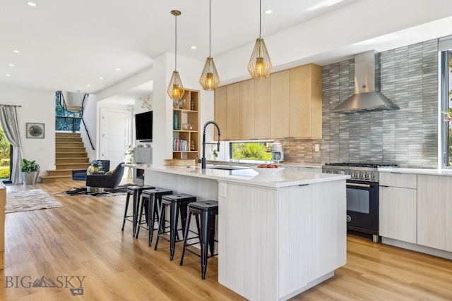 1492 Windrow Dr, Bozeman, MT 59718 - kitchen featuring high end stove, wall chimney exhaust hood, modern cabinets, tasteful backsplash, and recessed lighting