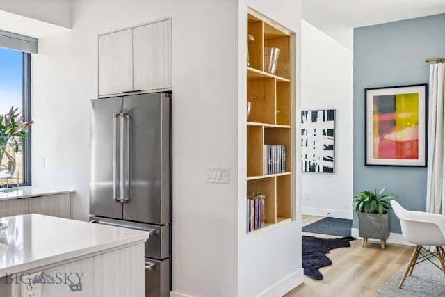 1492 Windrow Dr, Bozeman, MT 59718 - kitchen with high quality fridge, modern cabinets, light wood-type flooring, and light countertops