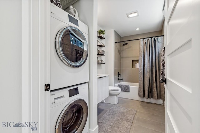 1492 Windrow Dr, Bozeman, MT 59718 - washroom with estacked washer and dryer and light tile patterned floors
