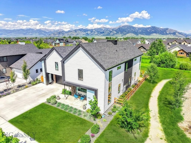 1492 Windrow Dr, Bozeman, MT 59718 - view of front of home with a residential view, driveway, a mountain view, and a front lawn