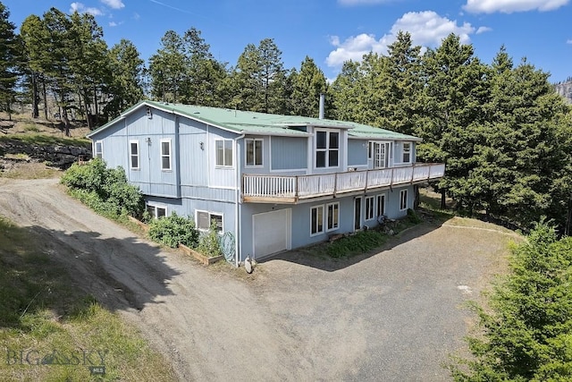 16 Friendspring Mt, Whitehall, MT 59759 - view of front of property featuring dirt driveway, a metal roof, a garage, and a deck