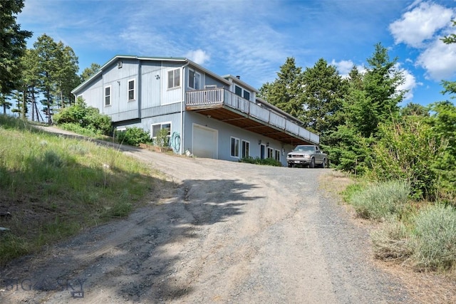 16 Friendspring Mt, Whitehall, MT 59759 - view of property exterior featuring dirt driveway, a garage, and a deck
