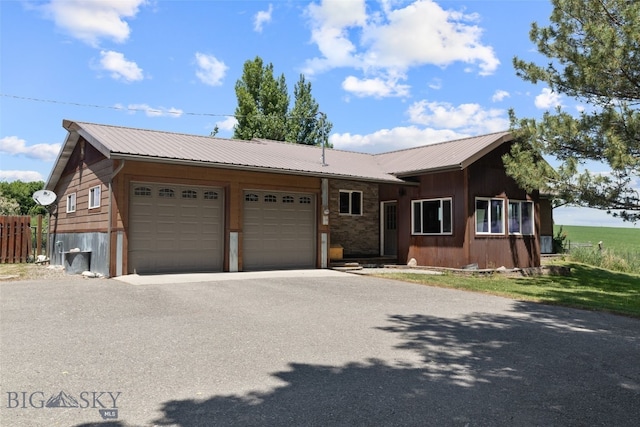 120 N Pine Butte, Bozeman, MT 59718 - view of front of property featuring an attached garage, asphalt driveway, and a metal roof