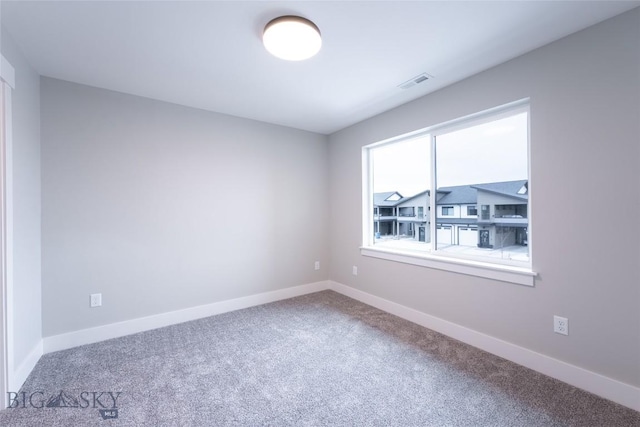 740 Rogers Way Unit A, Bozeman, MT 59718 - carpeted empty room featuring baseboards