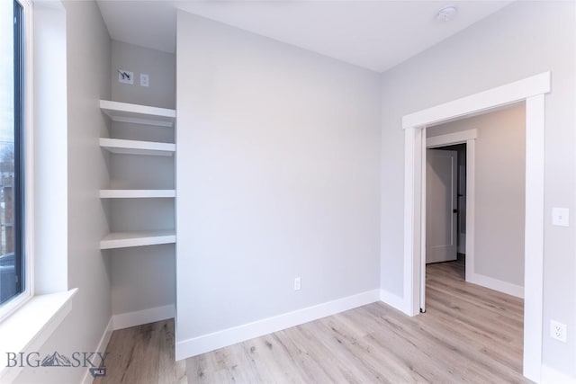 740 Rogers Way Unit A, Bozeman, MT 59718 - unfurnished bedroom with wood finished floors and baseboards